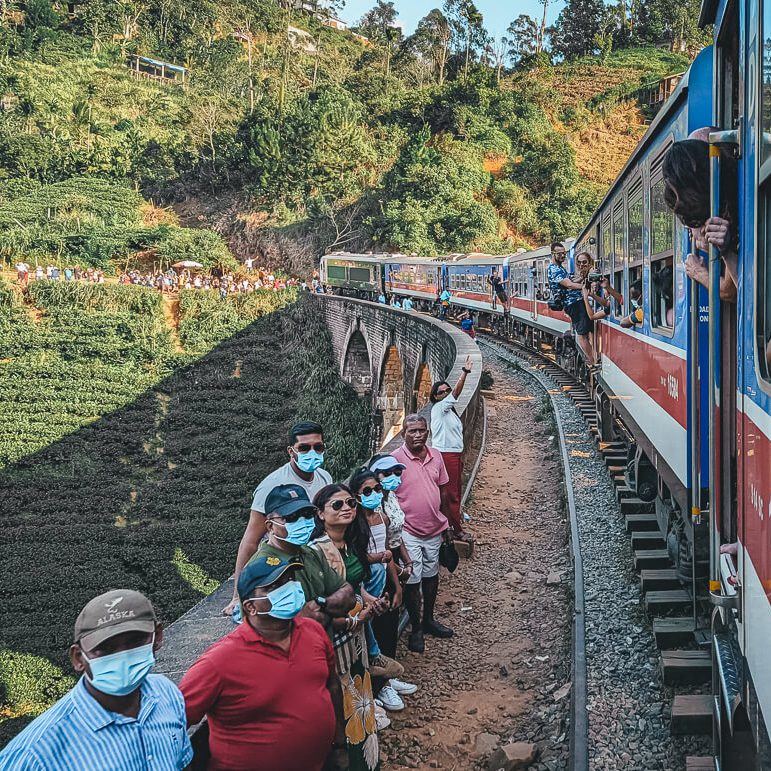 Throngs of tourists waiting at the Nine Arch bridge for the train